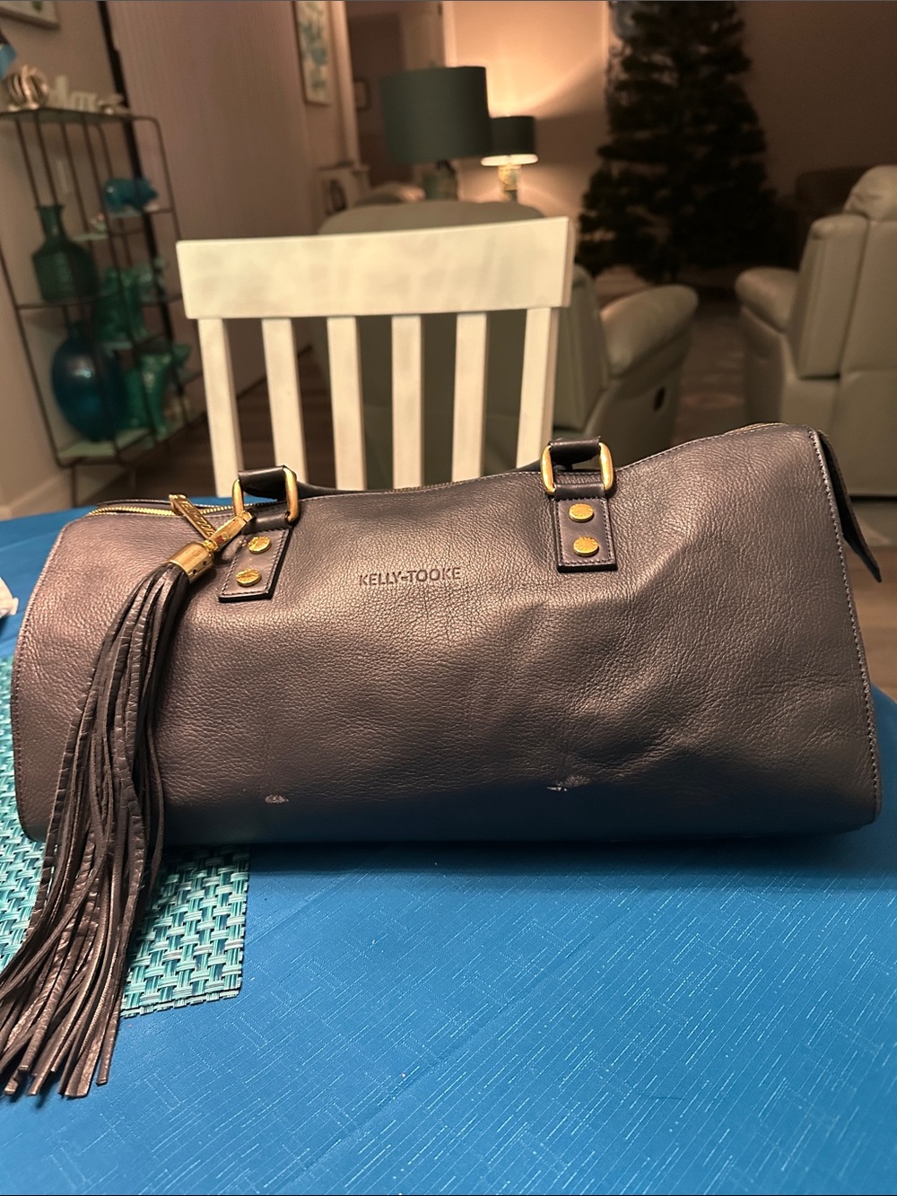Blue Leather Barrel Satchel with Tassel. Several white spots on bag as shown .
